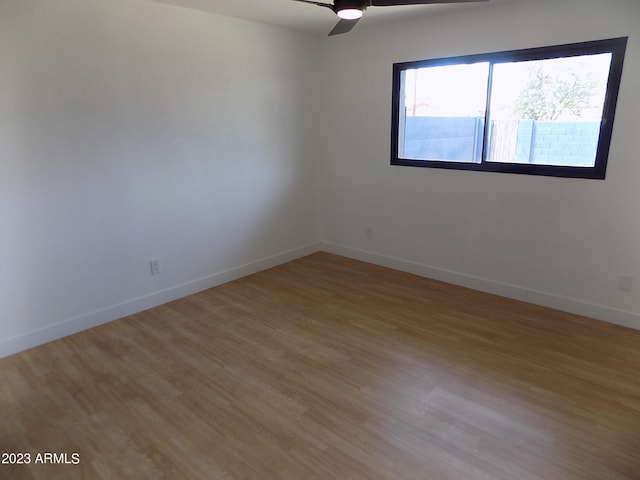 spare room with hardwood / wood-style floors and ceiling fan