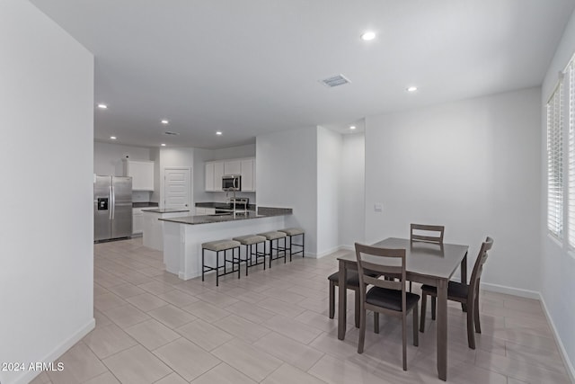 dining space with plenty of natural light and sink