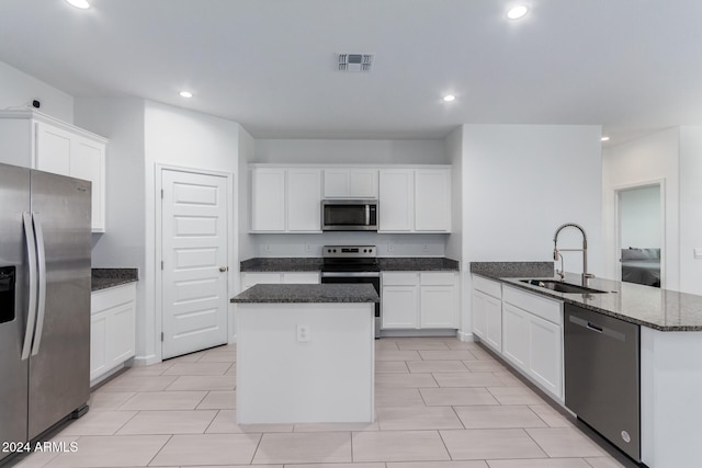 kitchen with white cabinetry, sink, an island with sink, and stainless steel appliances