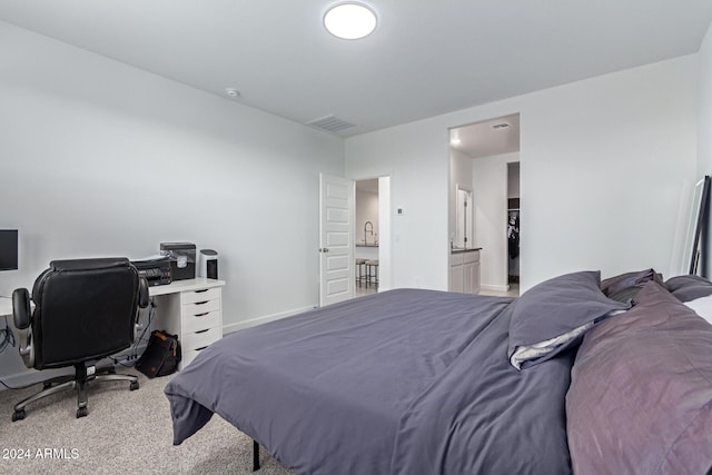 carpeted bedroom featuring ensuite bathroom