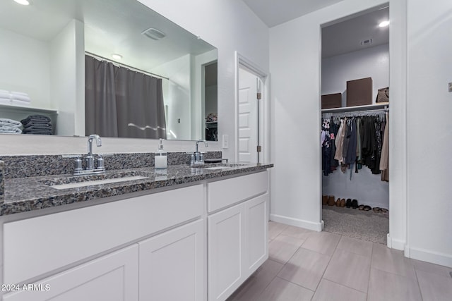 bathroom featuring tile patterned flooring and vanity