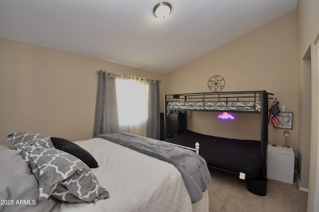 carpeted bedroom with lofted ceiling