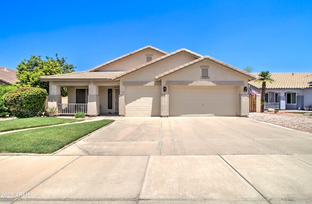 14298 W Amelia Ave, Goodyear, AZ 85395 - view of front of property featuring an attached garage, driveway, a tile roof, stucco siding, and a front yard