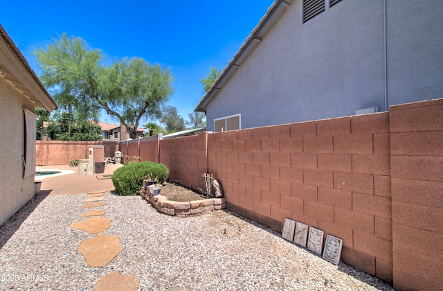 14298 W Amelia Ave, Goodyear, AZ 85395 - fenced backyard with a patio area