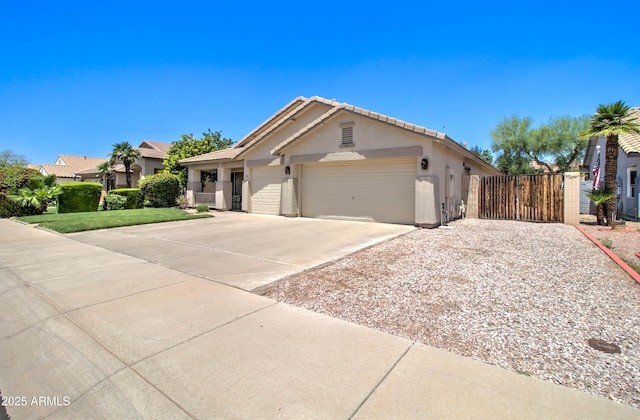 14298 W Amelia Ave, Goodyear, AZ 85395 - single story home featuring a gate, stucco siding, an attached garage, driveway, and fence