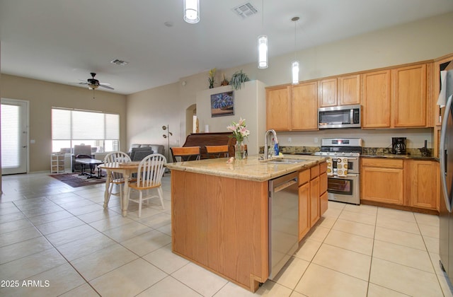 14298 W Amelia Ave, Goodyear, AZ 85395 - kitchen featuring stainless steel appliances, a sink, a ceiling fan, stone counters, and open floor plan