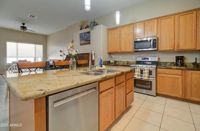 14298 W Amelia Ave, Goodyear, AZ 85395 - kitchen featuring appliances with stainless steel finishes, a sink, light tile patterned floors, a ceiling fan, and a kitchen island with sink