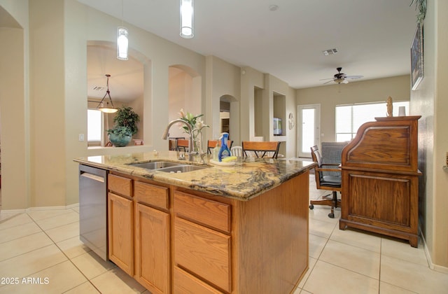 14298 W Amelia Ave, Goodyear, AZ 85395 - kitchen featuring a sink, stainless steel dishwasher, light tile patterned floors, and light stone countertops