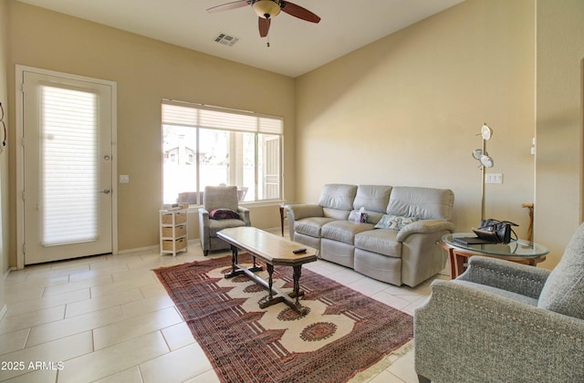 14298 W Amelia Ave, Goodyear, AZ 85395 - living room featuring ceiling fan, light tile patterned floors, and baseboards