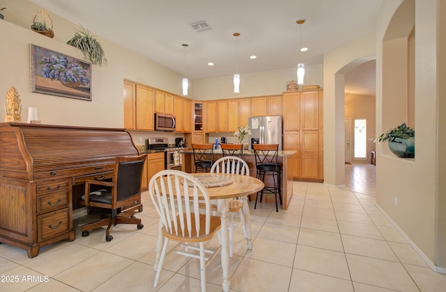 14298 W Amelia Ave, Goodyear, AZ 85395 - dining room featuring arched walkways, light tile patterned floors, and recessed lighting