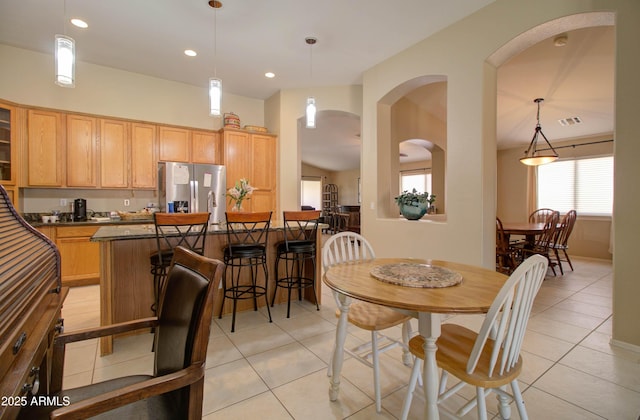 14298 W Amelia Ave, Goodyear, AZ 85395 - dining area featuring light tile patterned flooring, arched walkways, and recessed lighting