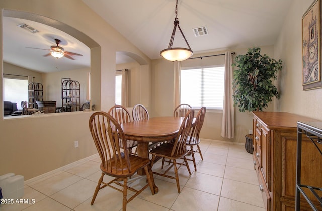 14298 W Amelia Ave, Goodyear, AZ 85395 - dining space featuring vaulted ceiling, healthy amount of natural light, ceiling fan, arched walkways, and light tile patterned flooring