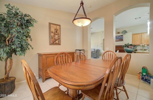 14298 W Amelia Ave, Goodyear, AZ 85395 - dining area with arched walkways and light tile patterned floors