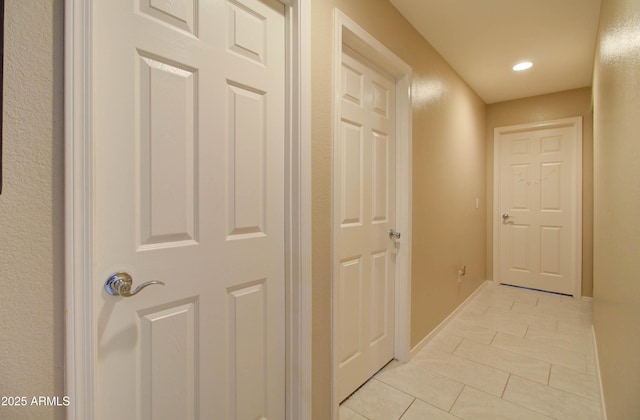 14298 W Amelia Ave, Goodyear, AZ 85395 - hall with light tile patterned floors, baseboards, and recessed lighting
