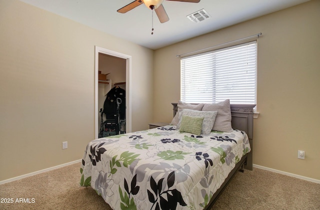 14298 W Amelia Ave, Goodyear, AZ 85395 - bedroom with carpet flooring, a spacious closet, baseboards, a closet, and a ceiling fan