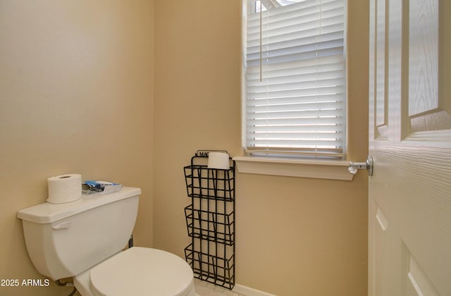 14298 W Amelia Ave, Goodyear, AZ 85395 - bathroom featuring toilet and baseboards