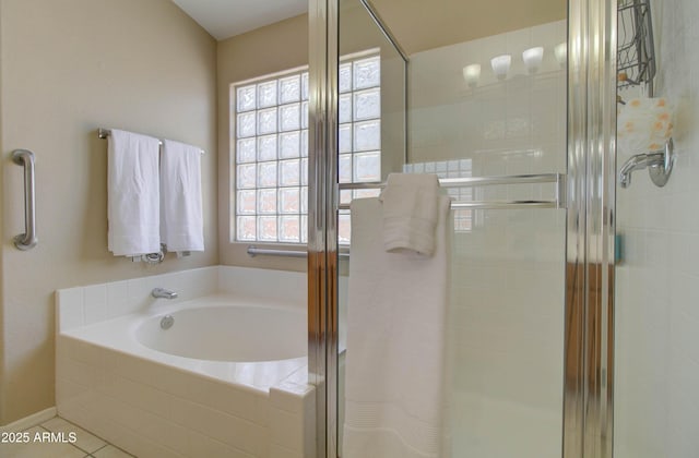 14298 W Amelia Ave, Goodyear, AZ 85395 - full bathroom featuring healthy amount of natural light, a stall shower, a garden tub, and tile patterned floors