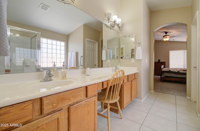 14298 W Amelia Ave, Goodyear, AZ 85395 - ensuite bathroom with ceiling fan, tile patterned flooring, double vanity, and a stall shower