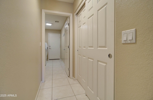 14298 W Amelia Ave, Goodyear, AZ 85395 - hallway featuring light tile patterned flooring and a textured wall