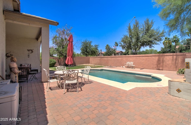 14298 W Amelia Ave, Goodyear, AZ 85395 - view of swimming pool featuring a patio, a fenced backyard, and outdoor dining space