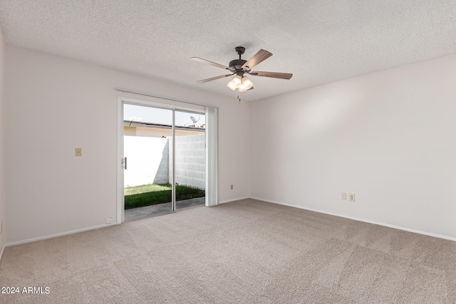 spare room featuring ceiling fan, carpet flooring, and a textured ceiling