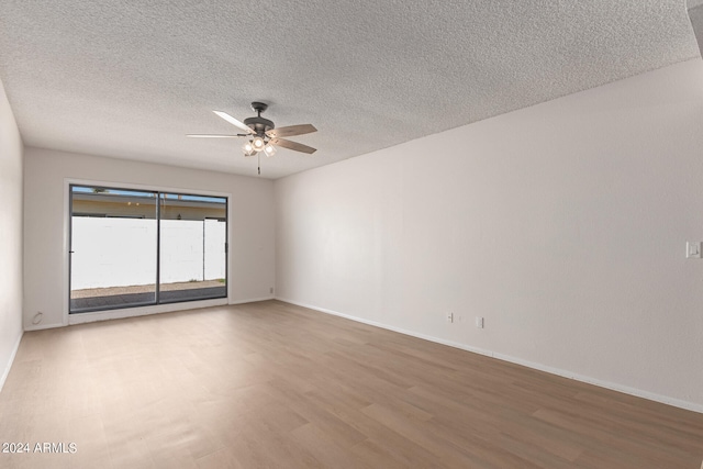 spare room featuring ceiling fan, a textured ceiling, and hardwood / wood-style floors