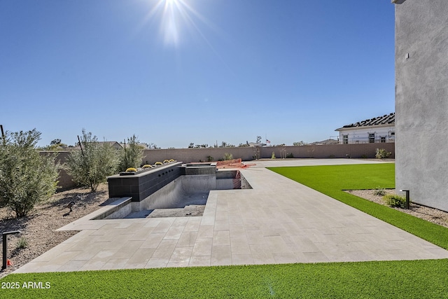 view of pool featuring a yard and a patio