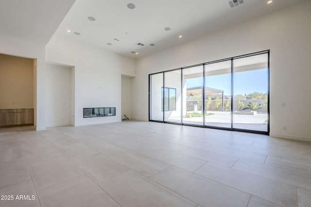 unfurnished living room with a high ceiling