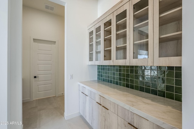 bar with backsplash and light tile patterned floors