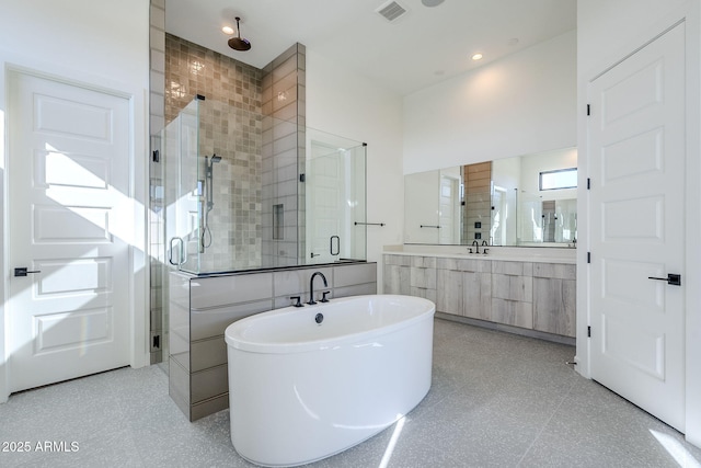 bathroom with vanity and independent shower and bath