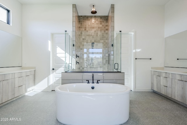 bathroom featuring vanity and shower with separate bathtub