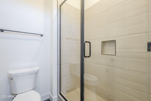 bathroom with an enclosed shower and toilet