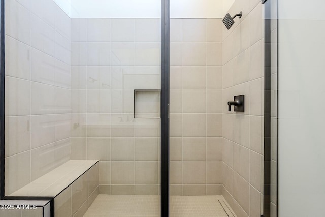 bathroom with a tile shower