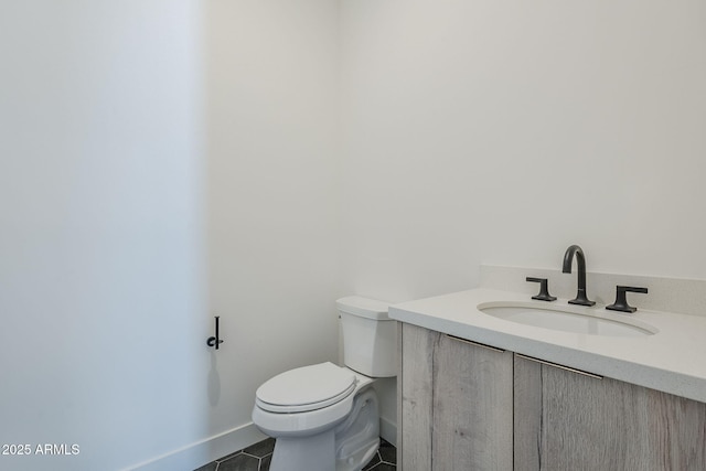 bathroom featuring vanity, toilet, and tile patterned flooring