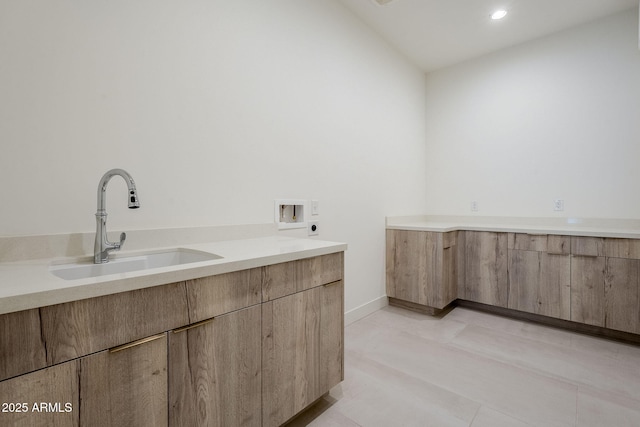 bathroom with lofted ceiling, sink, and tile patterned floors