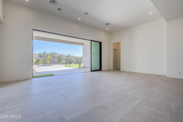 unfurnished room featuring a high ceiling