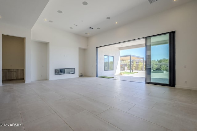 unfurnished living room with a towering ceiling