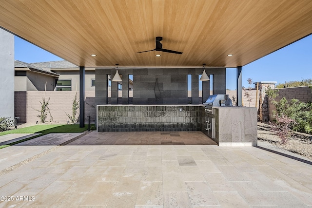 view of patio / terrace with grilling area, ceiling fan, and exterior kitchen