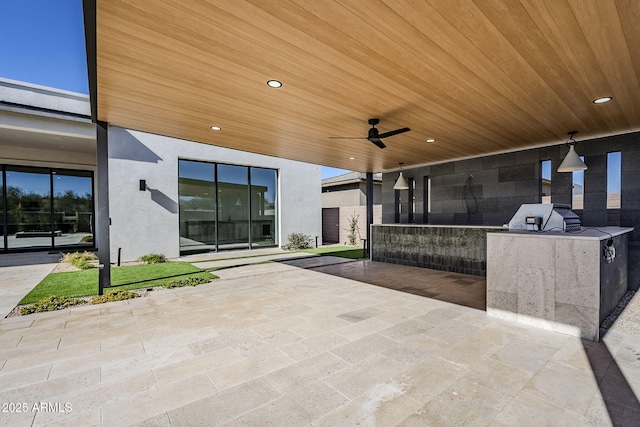 view of patio with area for grilling, a grill, and ceiling fan