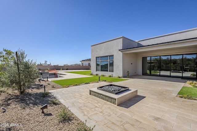 view of patio / terrace featuring an outdoor fire pit