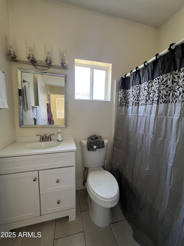 bathroom with tile patterned flooring, vanity, a shower with curtain, and toilet