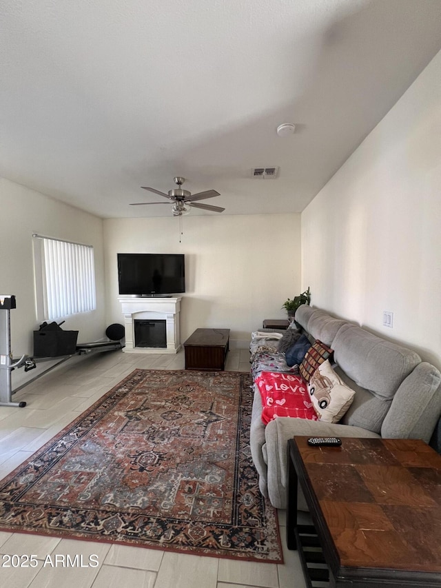 living room featuring tile patterned floors and ceiling fan