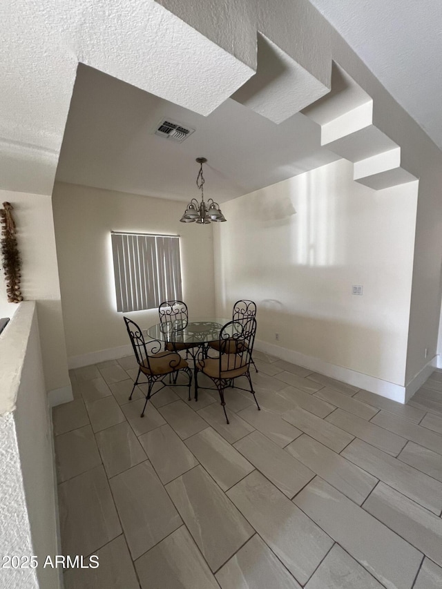 dining area featuring a notable chandelier