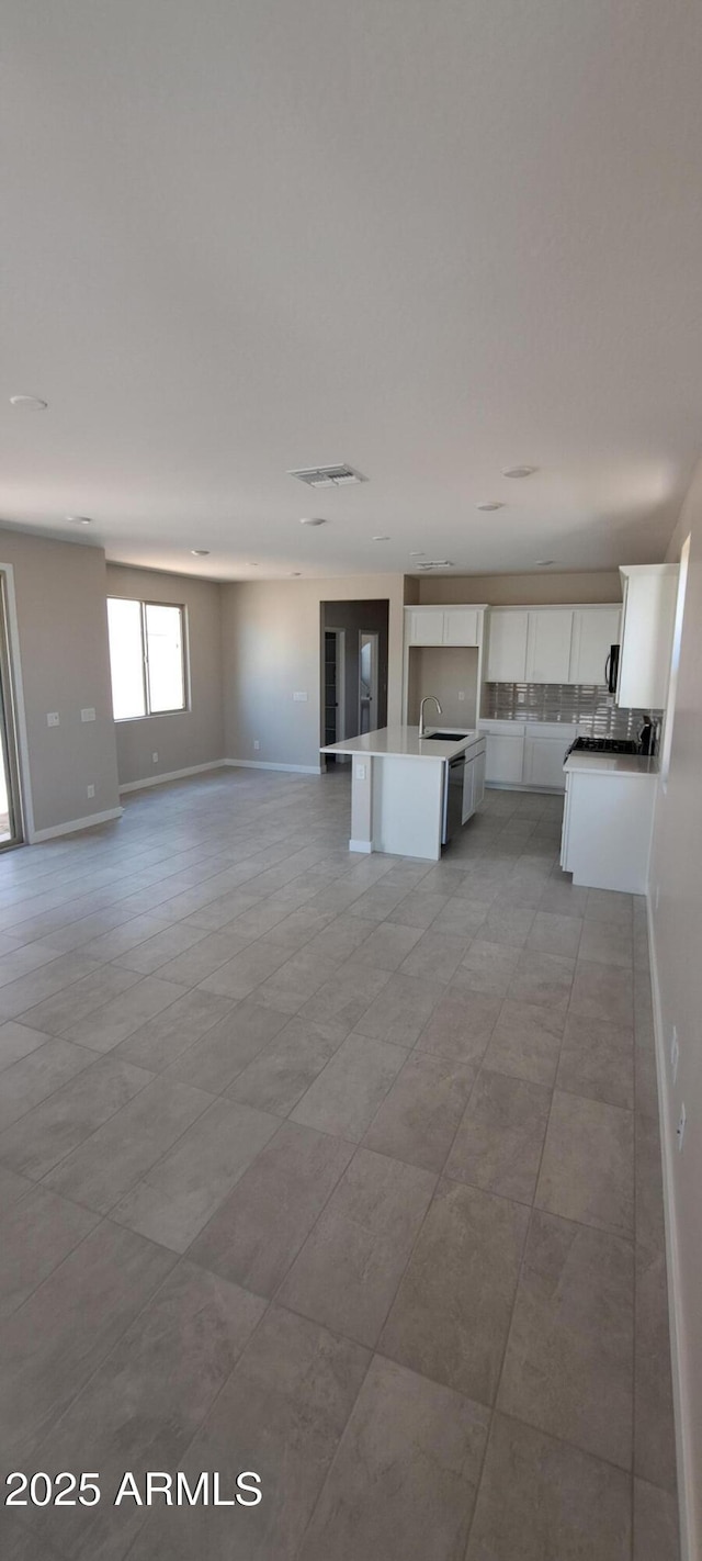 15593 S 180th Ln, Goodyear, AZ 85338 - unfurnished living room with baseboards and a sink