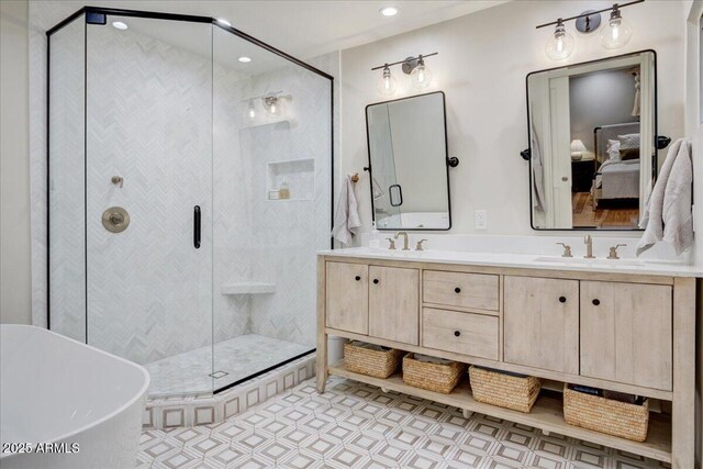 1831 E Rovey Ave, Phoenix, AZ 85016 - ensuite bathroom featuring double vanity, a shower stall, a freestanding tub, and recessed lighting