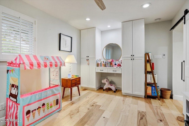 1831 E Rovey Ave, Phoenix, AZ 85016 - recreation room featuring a barn door, light wood-style floors, and recessed lighting