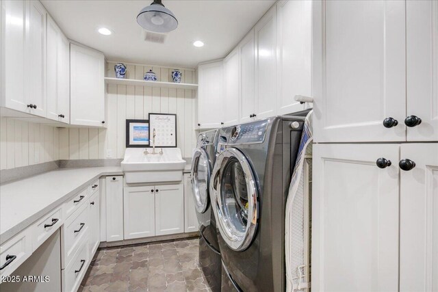 1831 E Rovey Ave, Phoenix, AZ 85016 - clothes washing area featuring washing machine and dryer, cabinet space, light stone finish flooring, and recessed lighting
