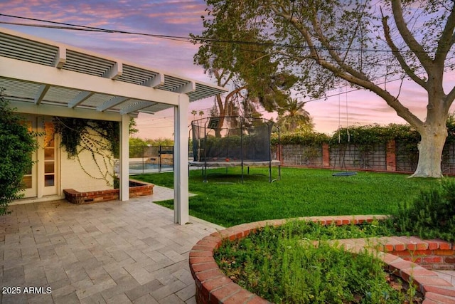 1831 E Rovey Ave, Phoenix, AZ 85016 - view of yard featuring a trampoline, a pergola, and a patio area
