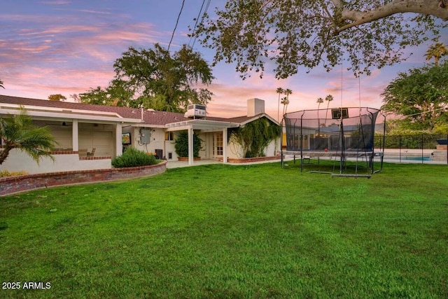 1831 E Rovey Ave, Phoenix, AZ 85016 - back of property with a trampoline, a patio area, and a pool