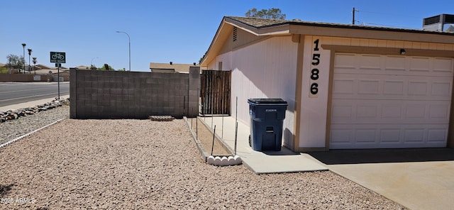 1586 S Lawther Dr, Apache Junction, AZ 85120 - view of side of property with an attached garage and a gate
